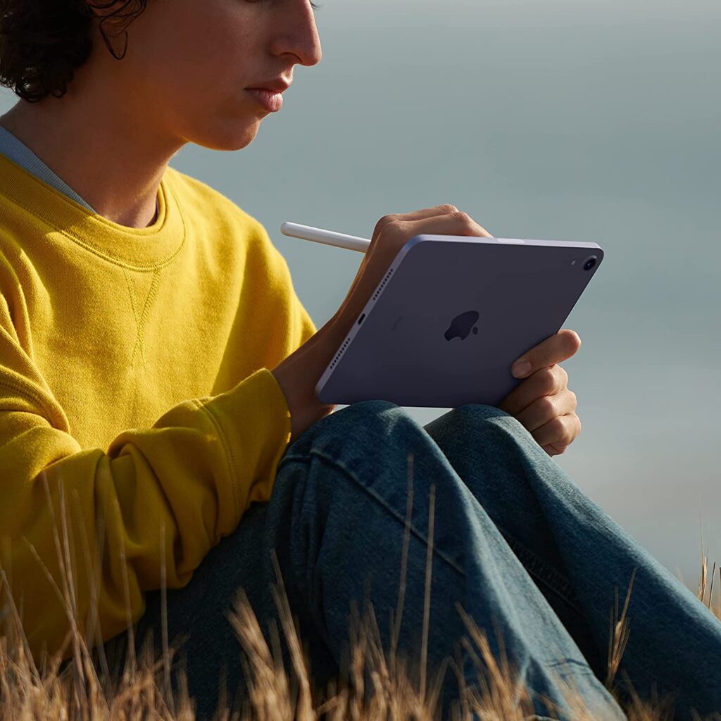 woman writing in 2021 Apple iPad Mini